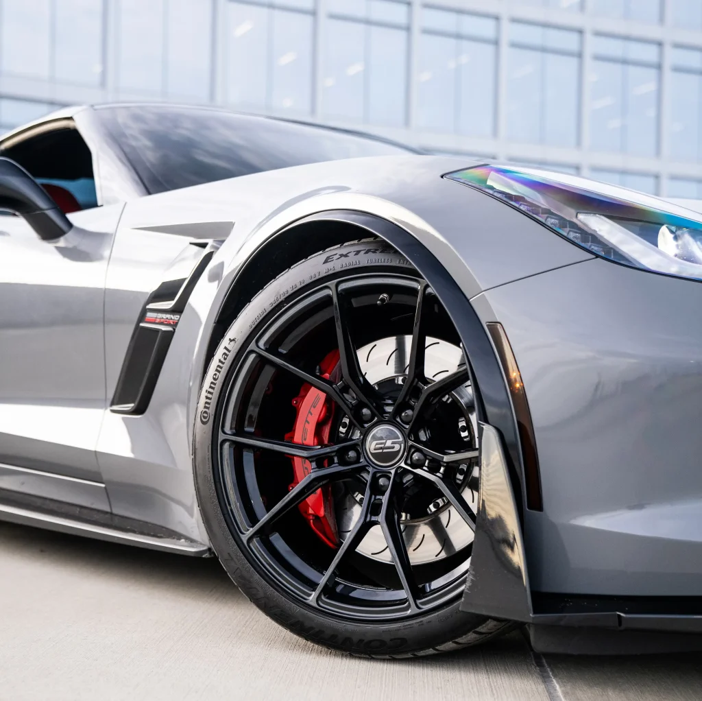 Black C7 Corvette with E5 aftermarket wheels close-up showing fitment and finish